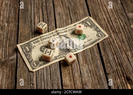 Playing dice on dollar bill Stock Photo