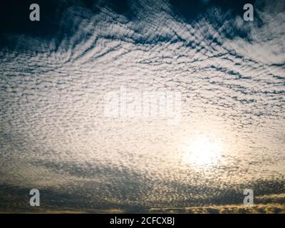 Illuminated background of beautiful calm sky with cirrus clouds at sunset Stock Photo