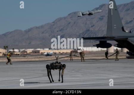 A Ghost Robotics Vision 60 prototype provides security at a simulated austere base during the Advanced Battle Management System exercise on Nellis Air Force Base, Nev., Sept. 3, 2020. The ABMS is an interconnected battle network - the digital architecture or foundation - which collects, processes and shares data relevant to warfighters in order to make better decisions faster in the kill chain. In order to achieve all-domain superiority, it requires that individual military activities not simply be de-conflicted, but rather integrated – activities in one domain must enhance the effectiveness o Stock Photo