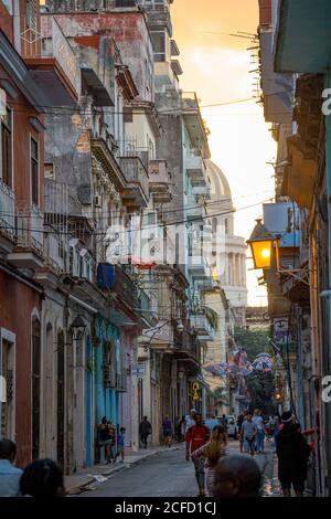 Cuban alley with colonial houses and view of Capitol at sunset, Old Havana, Cuba Stock Photo
