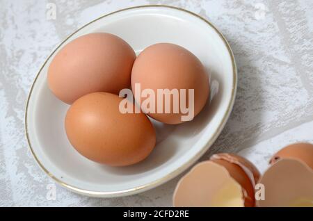 Three eggs in a white bowl Stock Photo