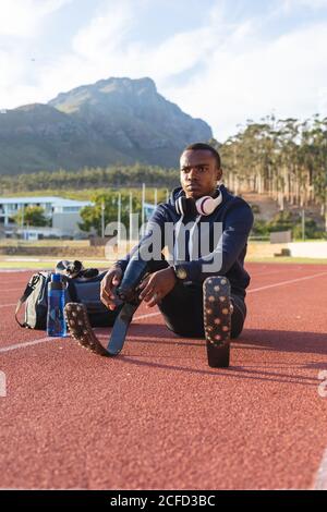 Male athlete wearing prosthetic leg on race track Stock Photo - Alamy