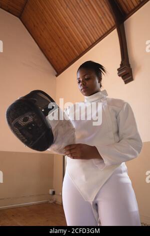 Woman wearing fencing outfit Stock Photo