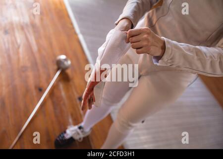 Woman wearing fencing outfit Stock Photo