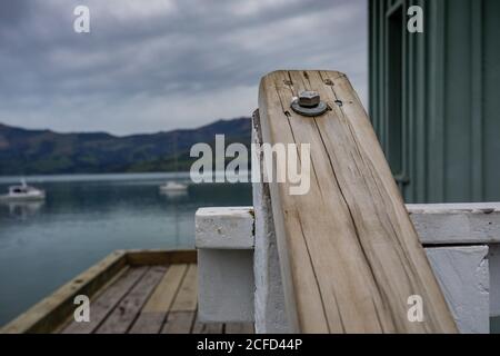 Wooden handle on the jetty in Akaroa harbor Stock Photo