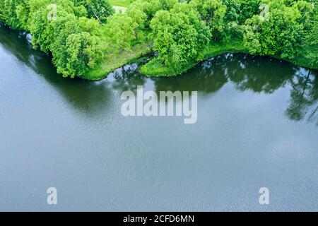 aerial top view of green summer forest on lake shore. rural landscape Stock Photo