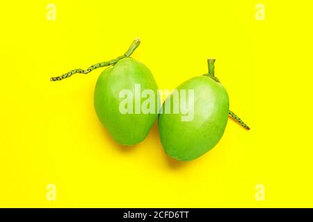 Fresh young coconuts on yellow background. Top view Stock Photo