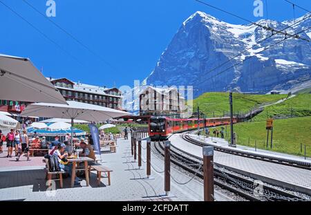 Kleine Scheidegg with restaurant terrace and Jungfrau Railway in front of the Eiger, Wengen, Jungfrau region, Bernese Alps, Bernese Oberland, Canton Stock Photo