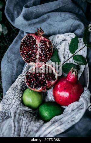 Various fruits lying on fabric on grass Stock Photo