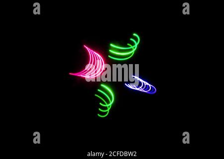 mixed light painting photography, long exposure, ripples and waves against a black background Stock Photo