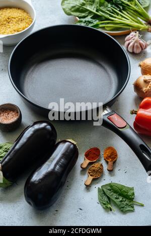 Fresh ingredients around empty frying pan Stock Photo
