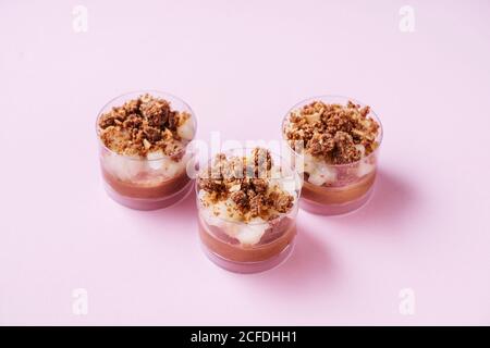 From above glass cups with delectable chocolate mousse placed on pink background Stock Photo