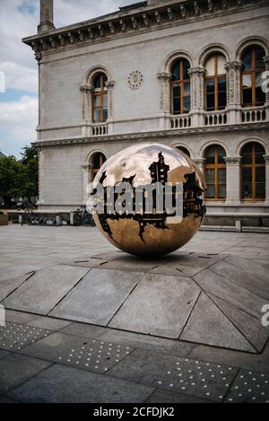 Sculpture 'Sphere Within Sphere' by Arnoldo Pomodoro on the grounds of Trinity College, Dublin, Ireland Stock Photo
