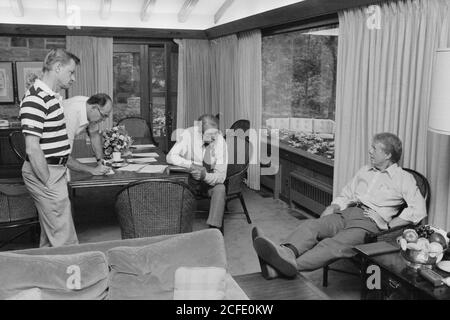 'Zbigniew Brzezinski, William Quandt, Cyrus Vance and Jimmy Carter at Camp David. ca.  09/17/1978' Stock Photo