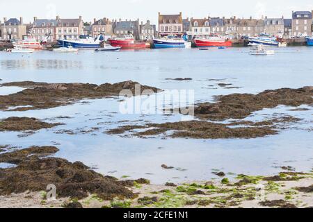 Boats in Barfleur harbor at low tide. The town is one of the most beautiful places in France. Stock Photo