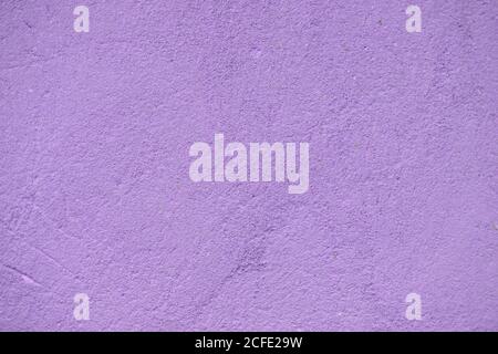 Violet concrete texture with potholes and scratches closeup. Stock Photo