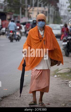 Dehradun, Uttarakhand/India- August 15 2020: A Sadhu wearing mask going on the road, facing camera. Stock Photo