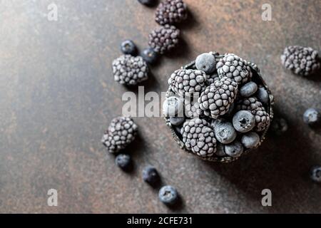Fresh Frozen blackberry on a dark background. Season concept, season. Healthy nutrition, vitamins. Stock Photo