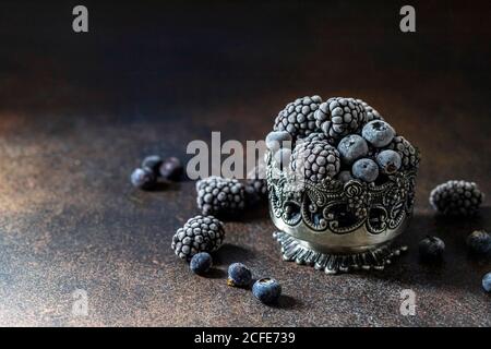 Fresh Frozen blackberry on a dark background. Season concept, season. Healthy nutrition, vitamins. Stock Photo