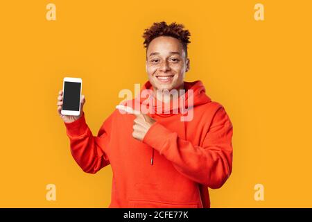 Young adult male pointing with finger on smartphone Stock Photo