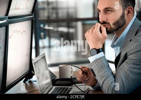 Stock trader analyzing stat and dynamic on forex charts Stock Photo