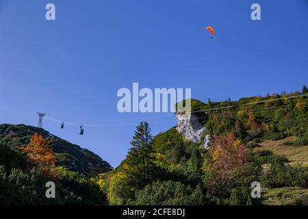 Paraglider near the Alpspitze against a blue sky over gondola, Hochalmbahn near Garmisch-Partenkirchen, Upper Bavaria, Bavaria, southern Germany, Stock Photo