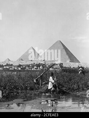 'Pyramids of Gizeh. The three pyramids with ''shaduf'' in foreground ca. 1934-1939' Stock Photo