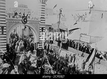 Original Caption:  State visit to Jerusalem of Wilhelm II of Germany in 1898. Emperor passing through arch; Hotel D'Europe in background.  - Location: Jerusalem ca.  1898 Stock Photo