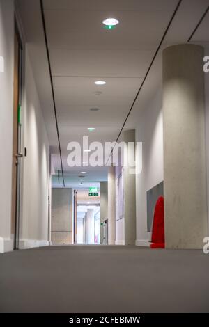 Empty long corridor in a modern office building. Stock Photo