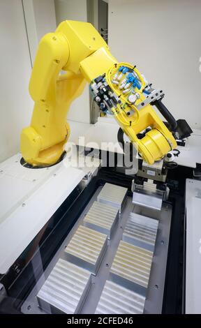 Bochum, North Rhine-Westphalia, Germany - robot arm equips a CNC milling machine with workpieces here at Stromboli Elektro und Feinwerktechnik on the Stock Photo