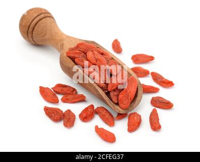 Dried goji berries in wooden scoop isolated on white Stock Photo