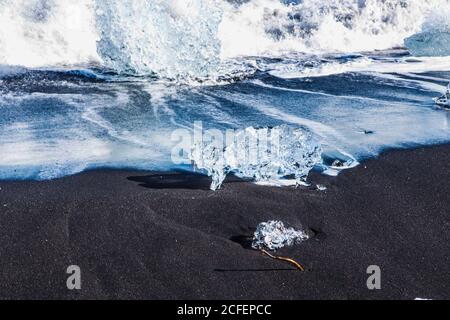 Diamond beach, big ice rocks on a black beach, at south coast of Iceland, on a sunny day, summer time. Stock Photo