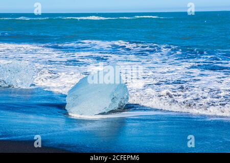 Diamond beach, big ice rocks on a black beach, at south coast of Iceland, on a sunny day, summer time. Stock Photo