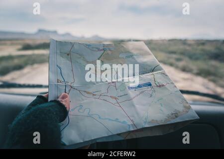 Man in car studying road map driving on road Stock Photo