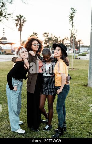 Multiethnic group of female hipsters cuddling with each one Stock Photo
