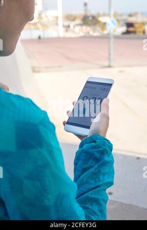 Close-up of Woman holding smartphone during workout Stock Photo