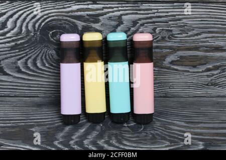 Colored markers. On brushed pine boards painted black and white. Stock Photo