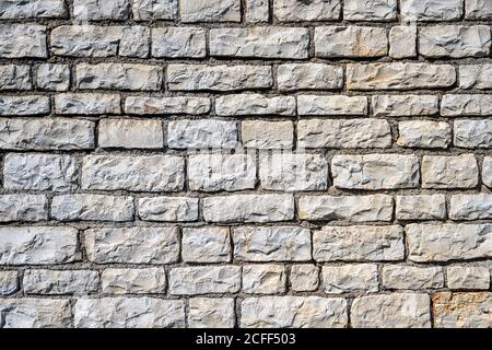 Background from an uniform natural stone wall Stock Photo