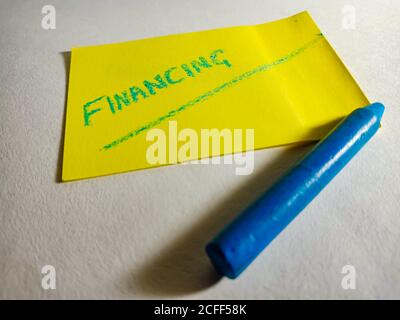 Financing word displayed on paper slip concept for educational informative awareness.