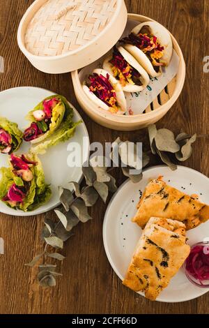 Various selection of different plates placed in wooden table Stock Photo