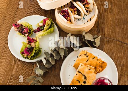 Various selection of different plates placed in wooden table Stock Photo