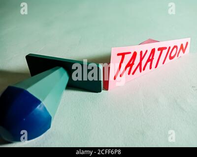 Taxation word displayed on paper slip concept for educational informative awareness.