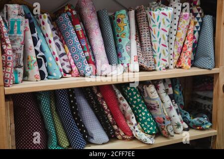 Shelf with cloth for work in storage room of tailor workshop Stock Photo