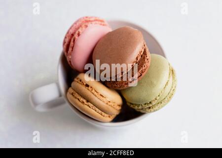 Bowl of macaroons on table Stock Photo