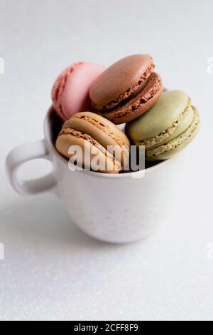 Bowl of macaroons on table Stock Photo