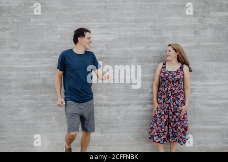 man and Woman looking at each other at nearby street wall Stock Photo
