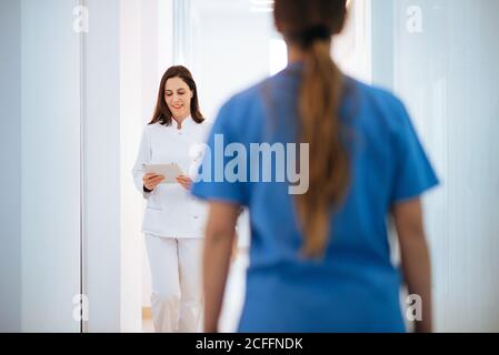 Doctor in white uniform walking along corridor Stock Photo