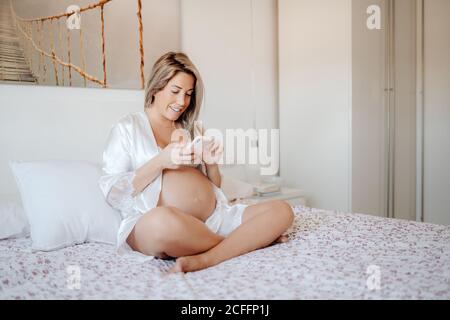 woman in white bra and shirt posing near black stool isolated on grey Stock  Photo - Alamy