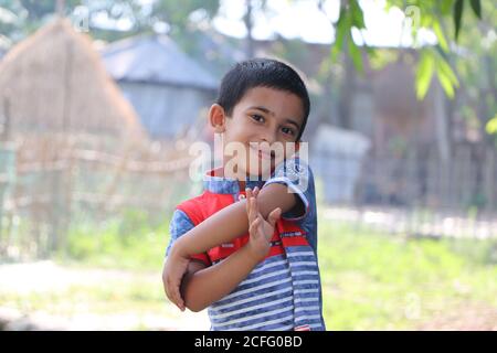Cute little boy child smiling, expressing happiness while posing for photo in the village Stock Photo