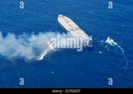 (200905) -- COLOMBO, Sept. 5, 2020 (Xinhua) -- Fireboats extinguish fire of an oil tanker in the seas off Sri Lanka's eastern coast, on Sept. 5, 2020. The distressed oil tanker MT New Diamond which caught fire in the seas off Sri Lanka's eastern coast on Thursday has been towed 40 nautical miles away from shore and the fire is under control, the Sri Lanka navy said here Saturday. (Sri Lanka Air Force Media/Handout via Xinhua) Stock Photo